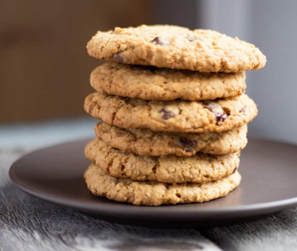 six oatmeal chocolate chunk cookies stacked on a plate