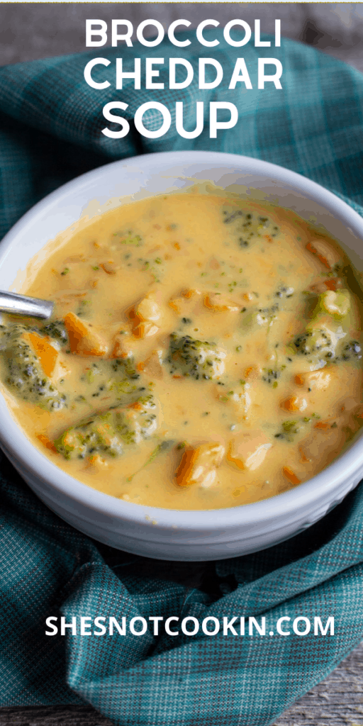 Broccoli Cheddar Soup in a white bowl with a spoon to the left of the bowl. The bowl is surrounded by teal coloured napkin.
