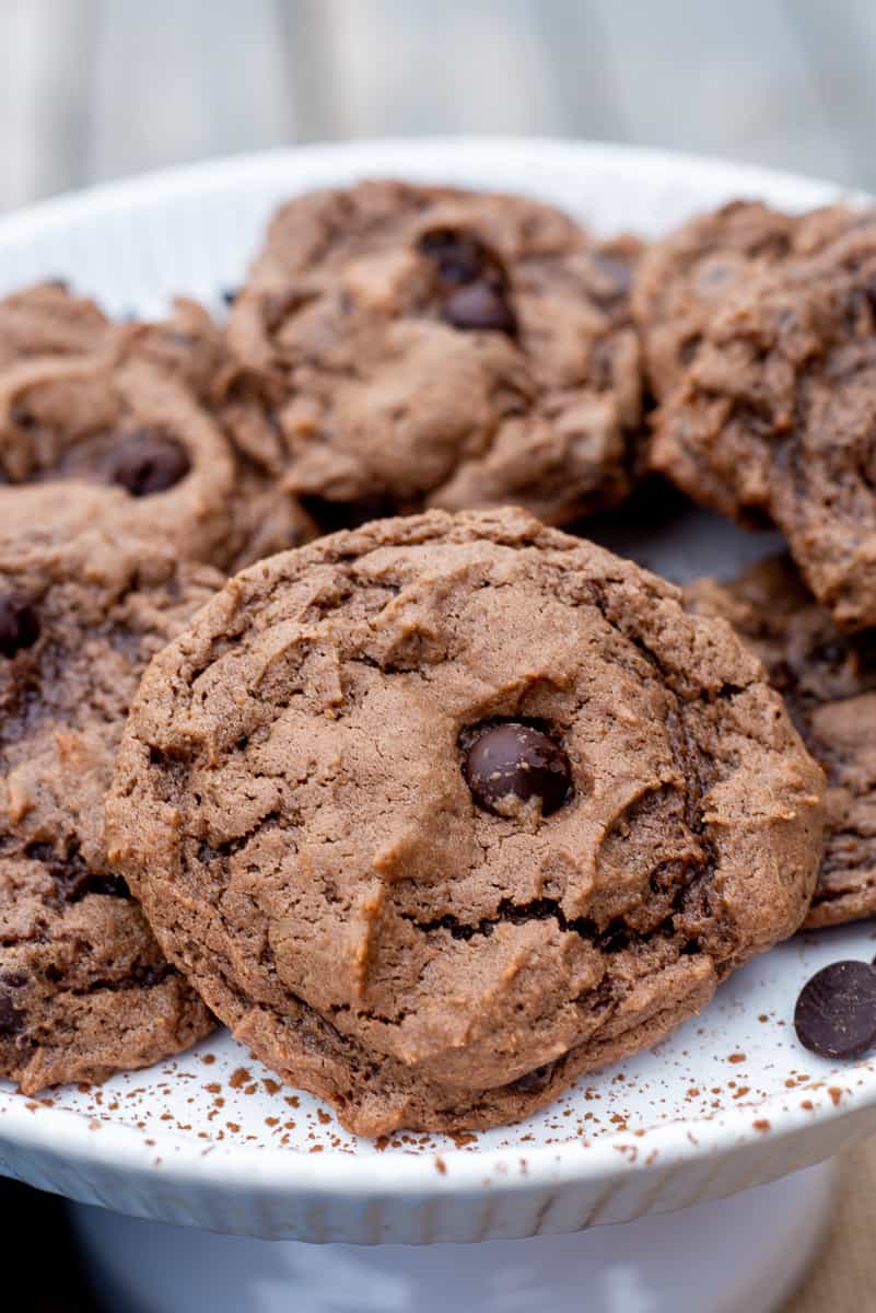Close up image of Double Chocolate Chip Cookies on a white plate.