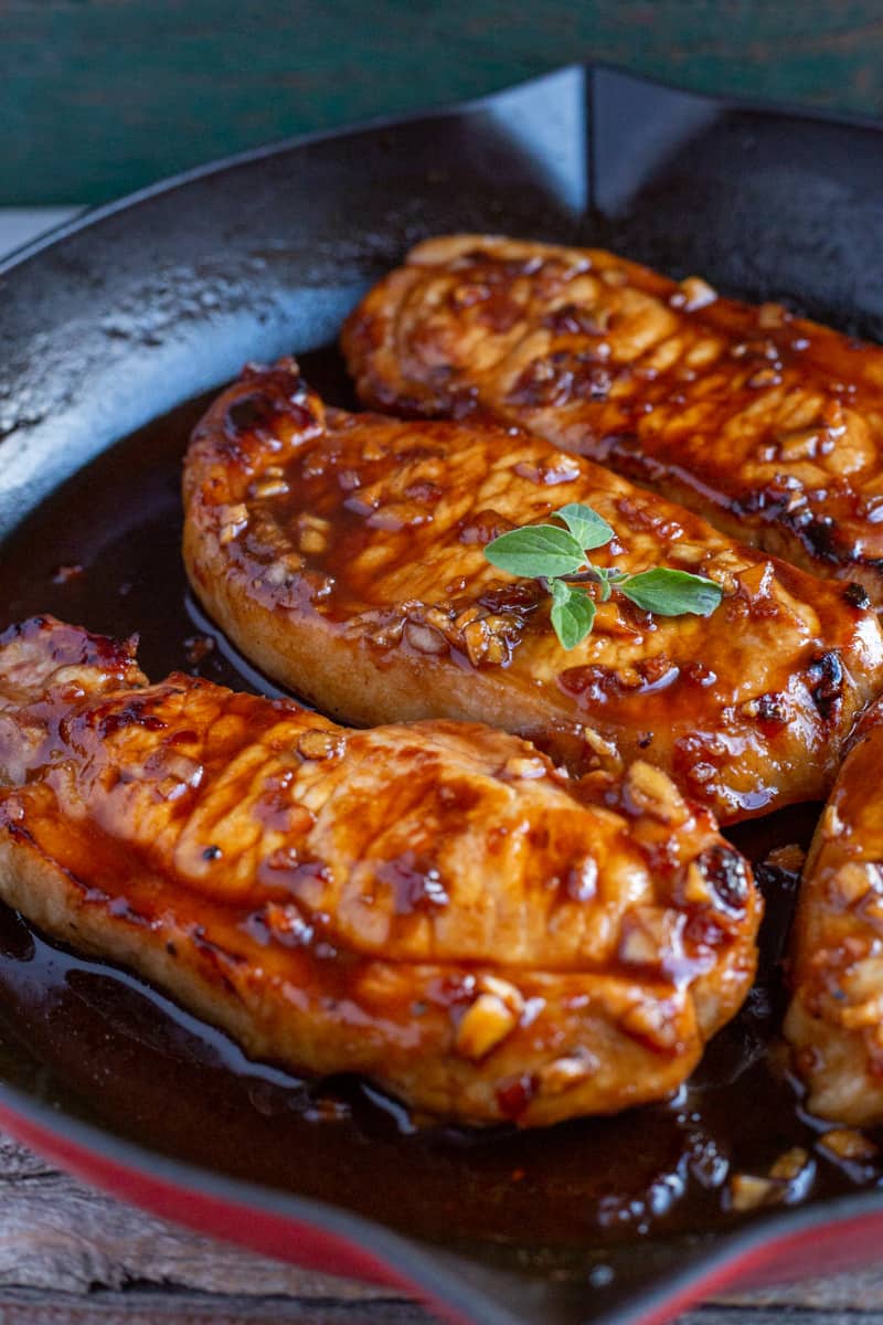 Honey garlic pork chops in cast iron skillet.