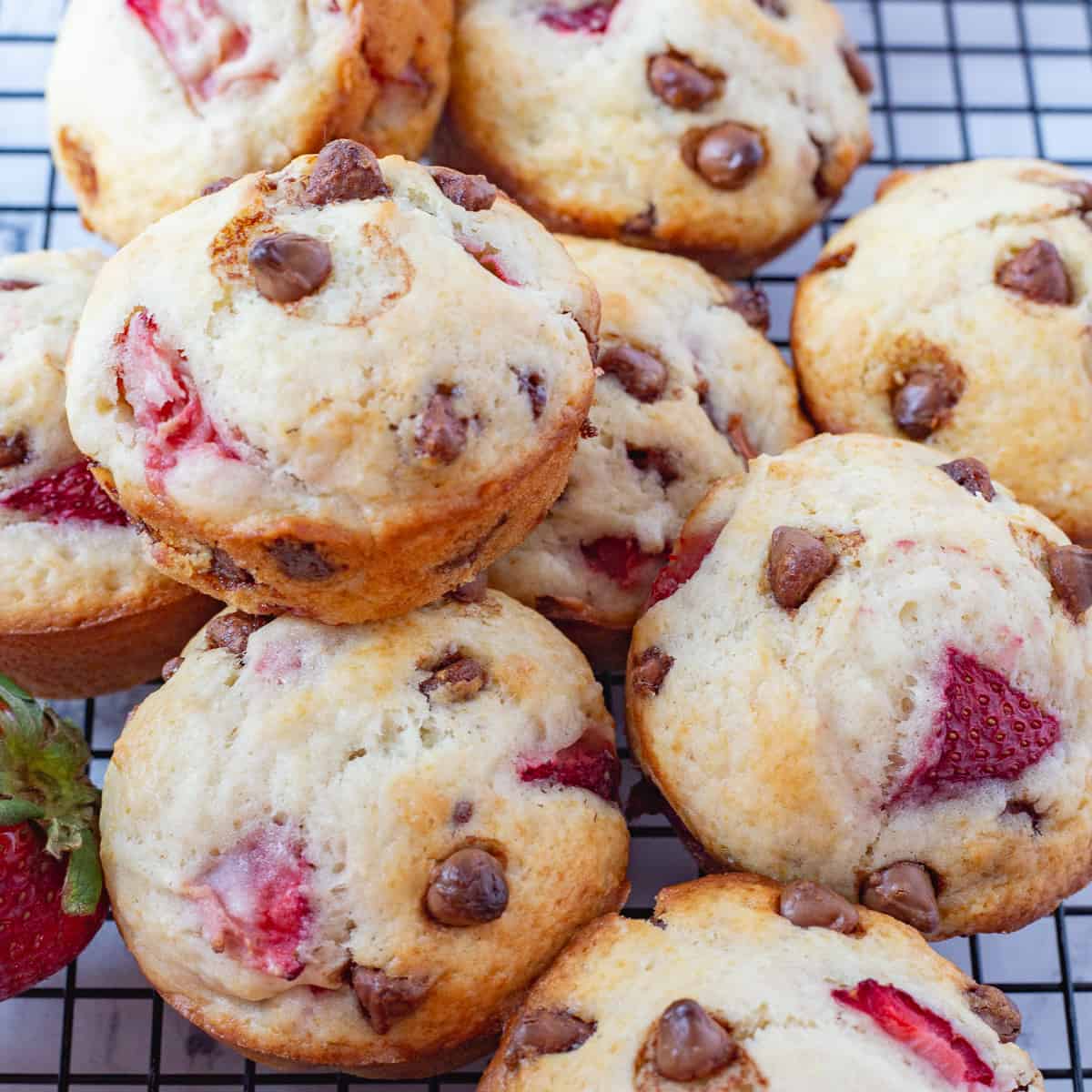 Strawberry chocolate chip muffins on wire cooling rack, stacked & ready to serve.