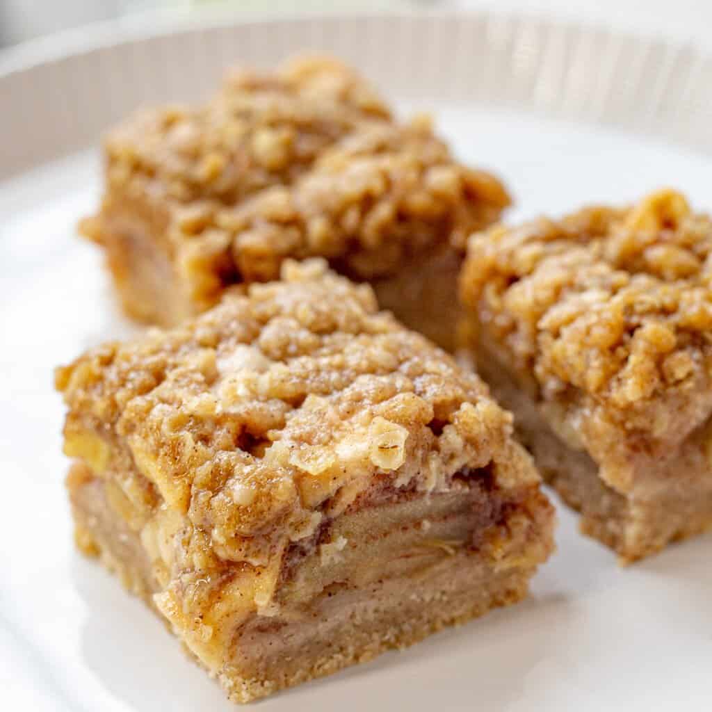 Apple pie bars on white plate.