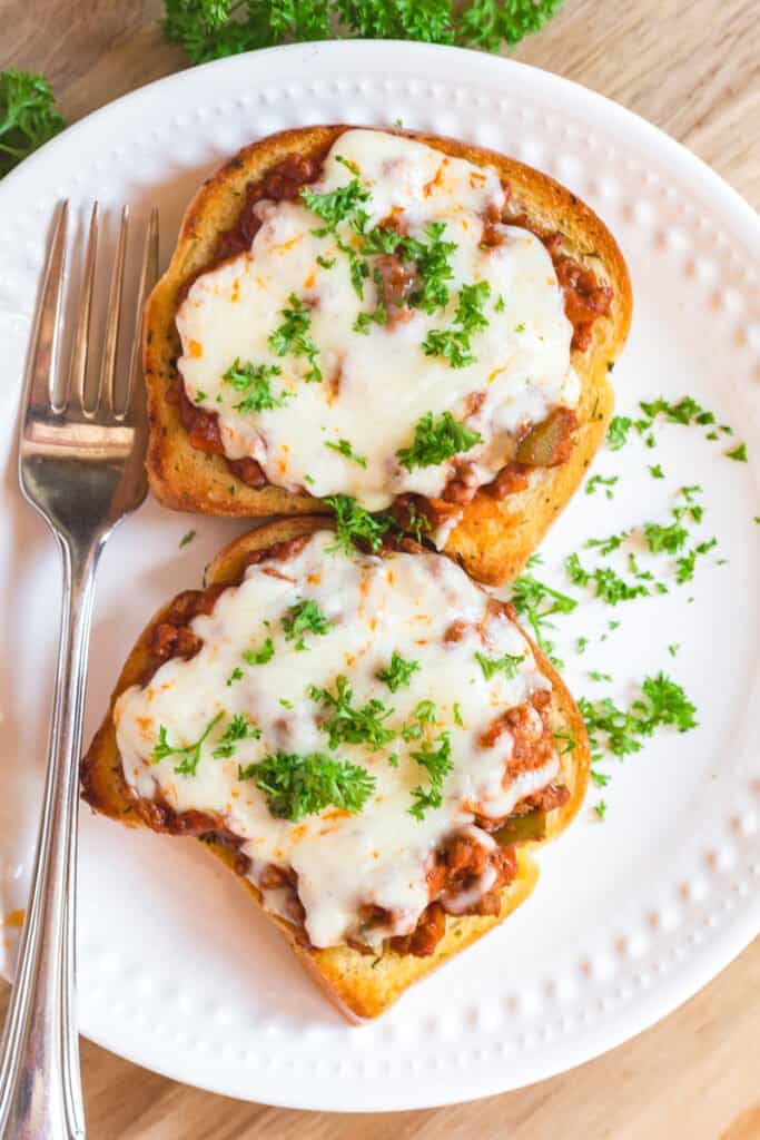 Texas toast sloppy joes on a white plate.