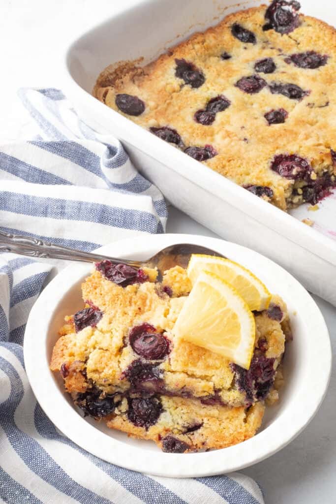 Lemon blueberry dump cake in a white bowl.