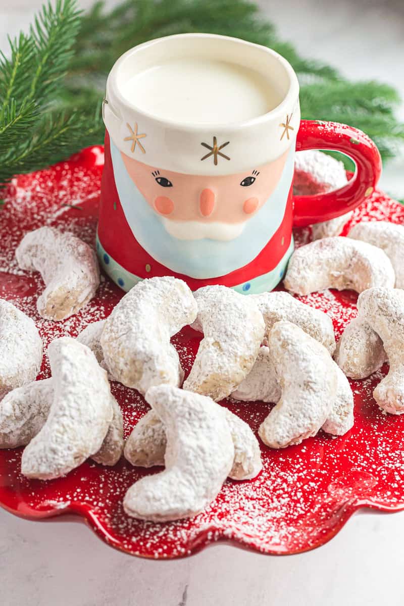 Butter pecan meltaway cookies on red plate with santa mug.