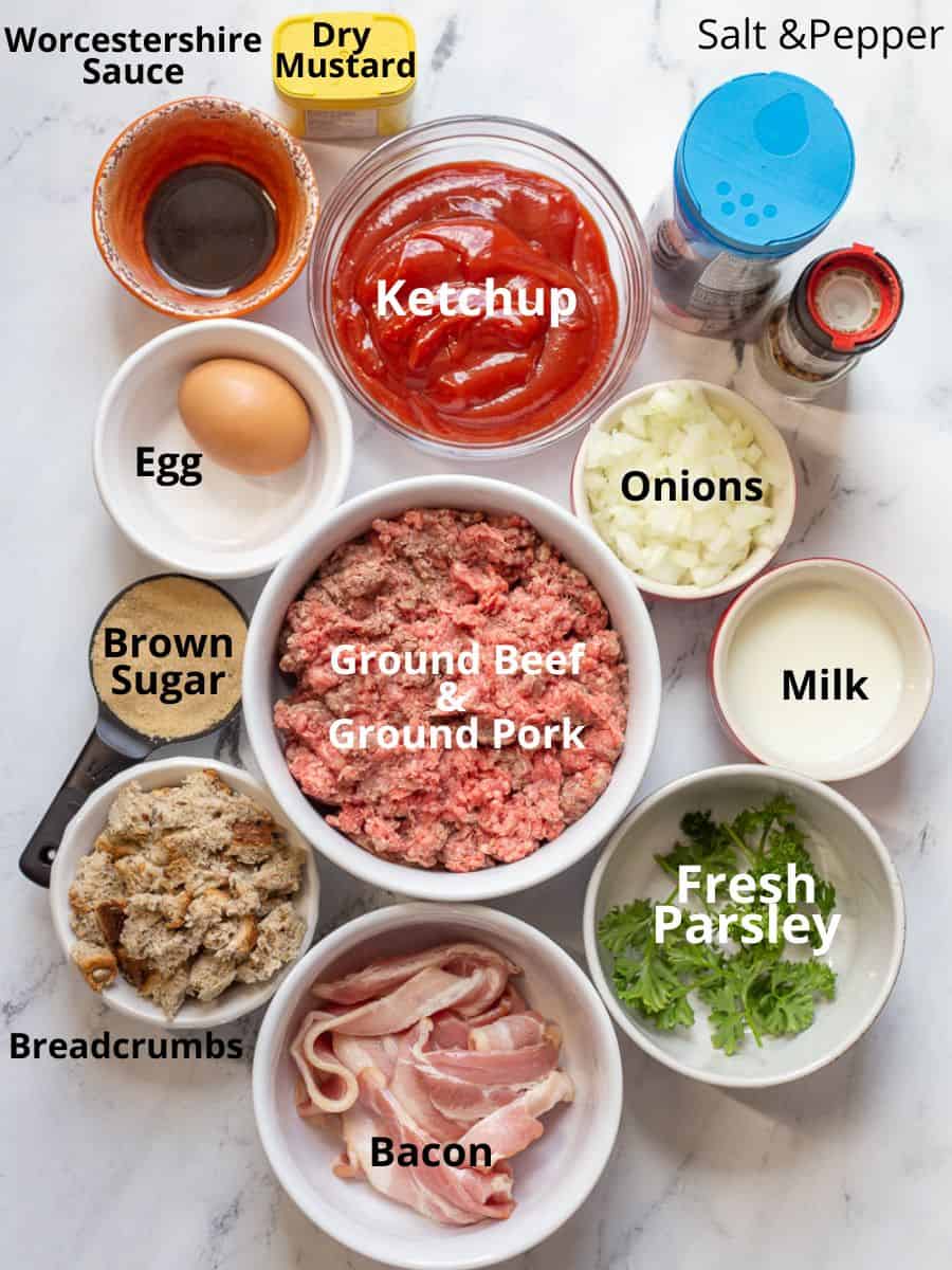 Ingredients for bacon-wrapped meatloaf on a marble board.