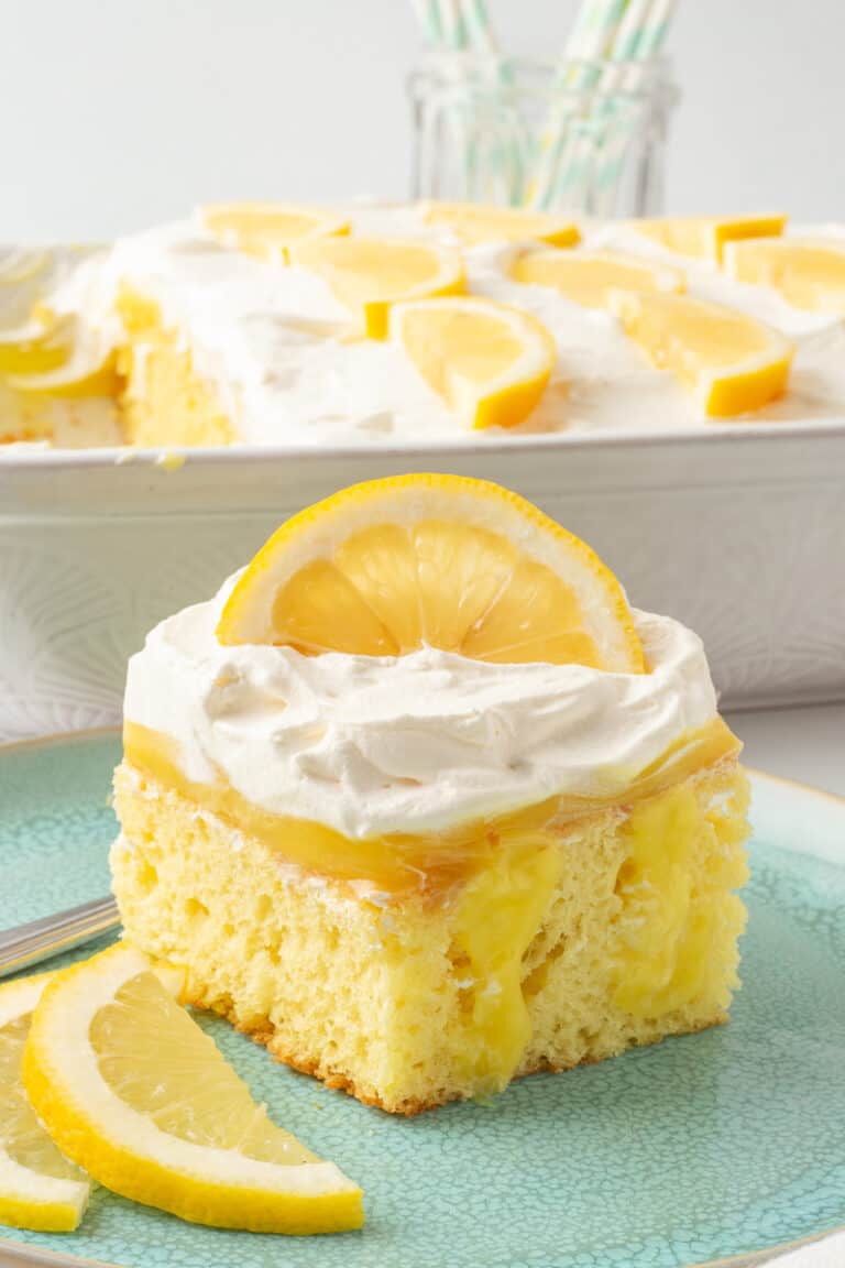 Lemon poke cake on a plate with a fork.