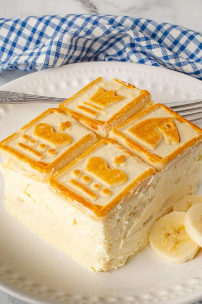 Serving of chessmen banana pudding on a white plate.