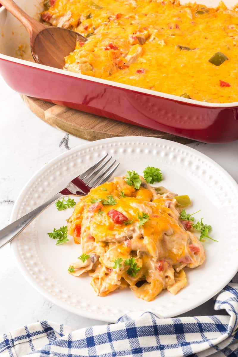Serving of king ranch casserole on white plate with a fork.