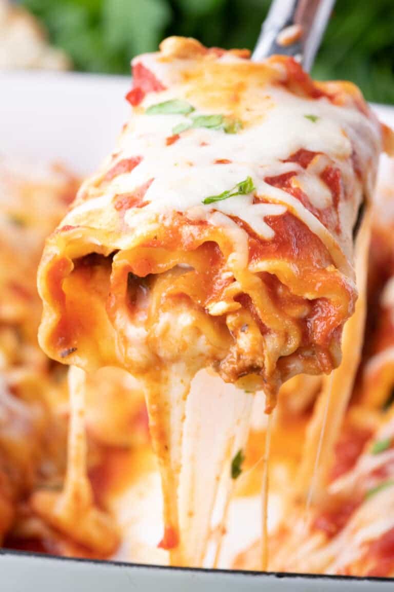 Close up image of lasagna rollup on a spoon.