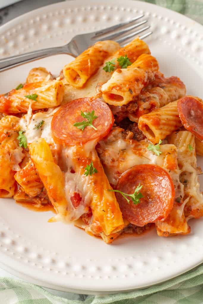 Pizza pasta casserole bake served on a white plate.
