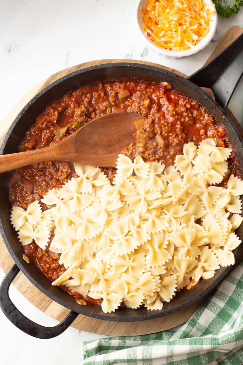 Cooked pasta bow ties are added to the sloppy joe meat sauce.