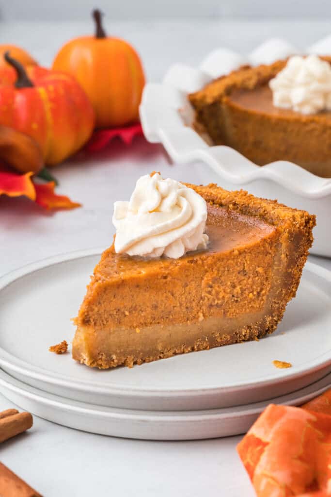 Pumpkin pie served on a white plate.