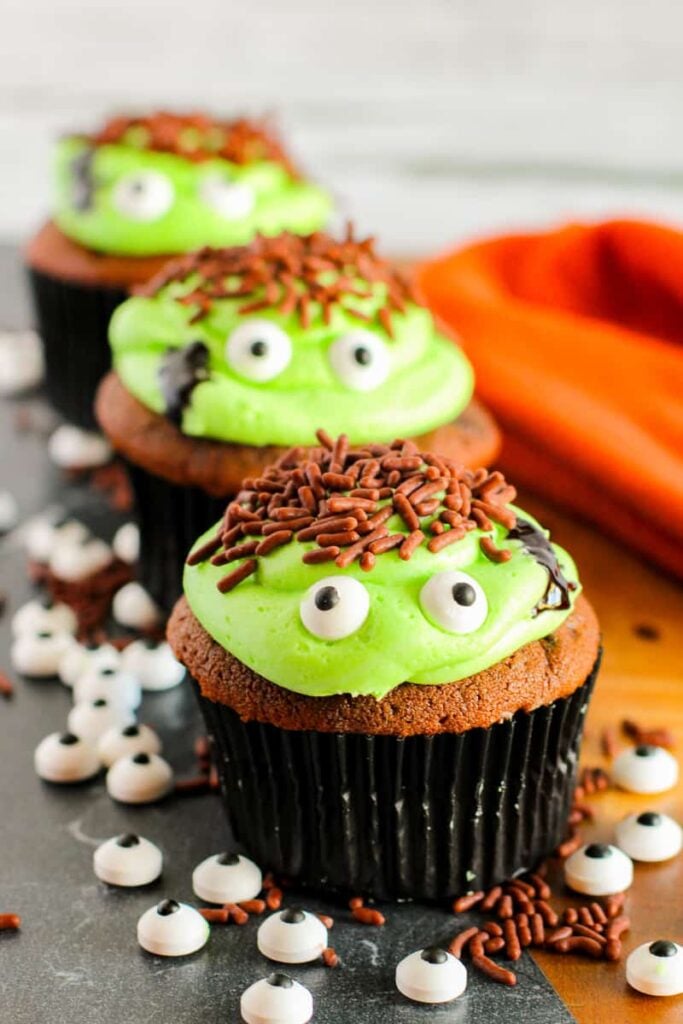 Halloween cupcakes on a wooden board.