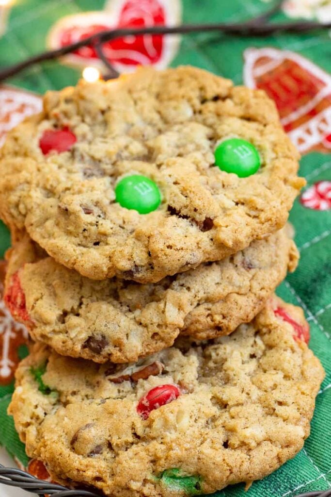 Christmas cowboy cookies stacked on a Christmas pot holder.