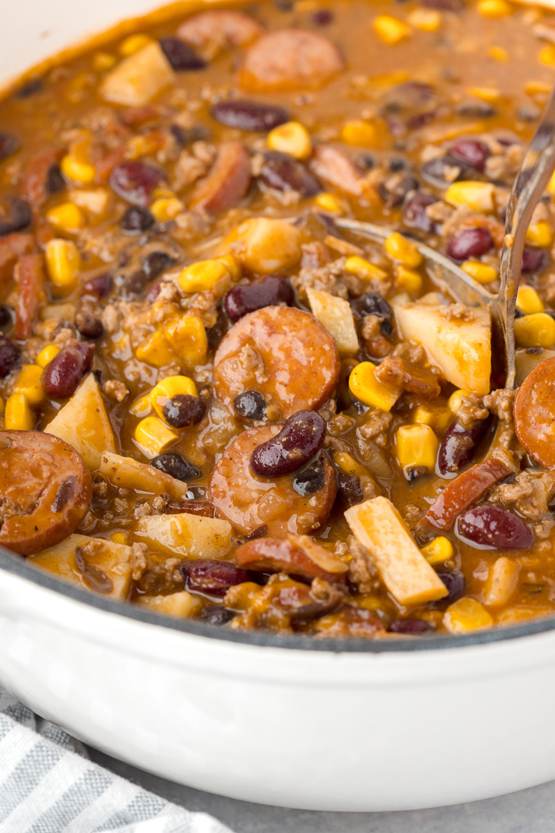 Hearty Texas stew scooped up in a ladle.