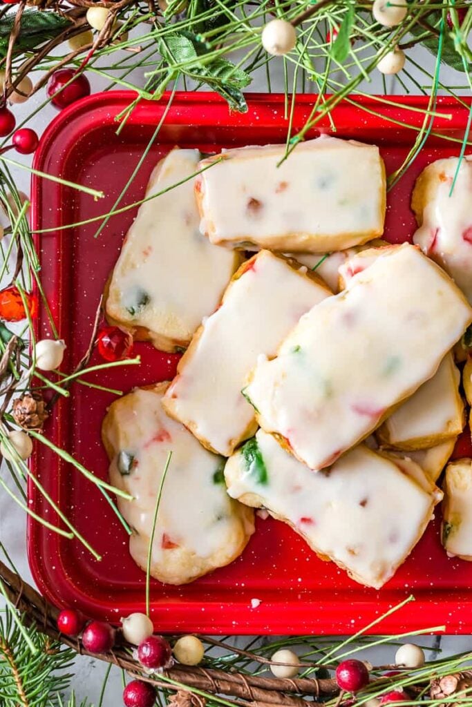 Glazed fruitcake shortbread on a red baking tray.