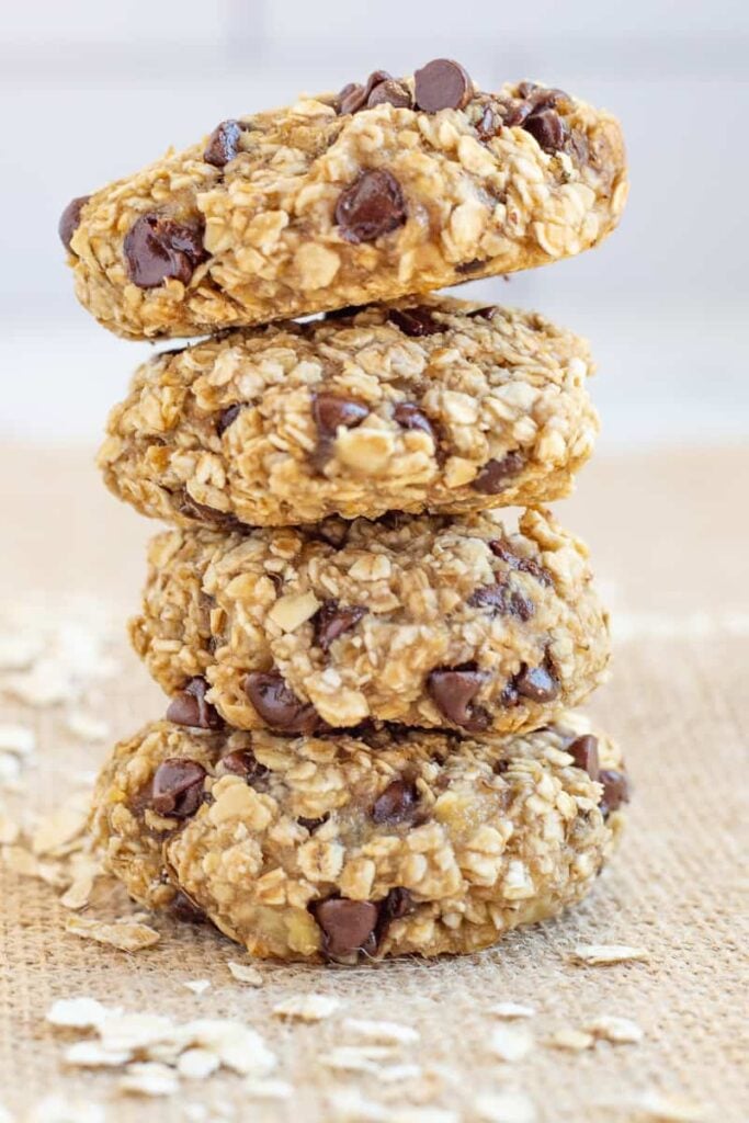 Banana oat cookies stacked on a burlap cloth.