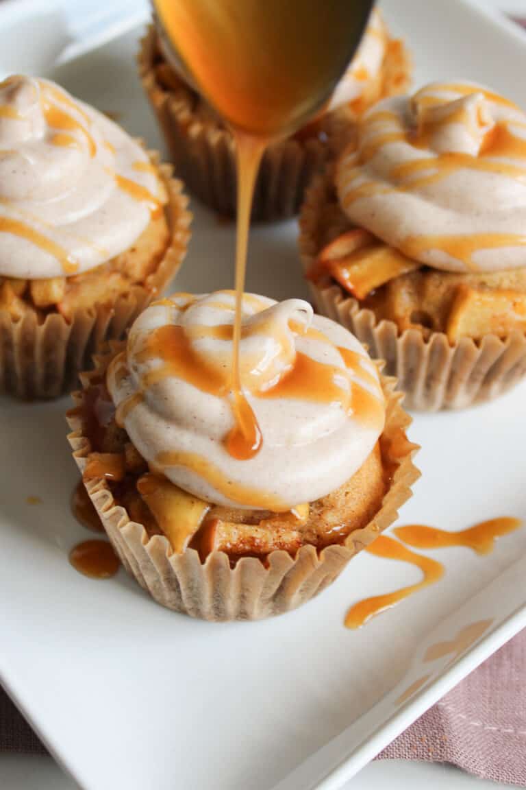 Apple cider cupcakes on a white plate.