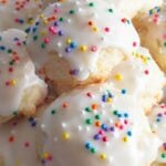 Ricotta cookies with sprinkles on white plate.