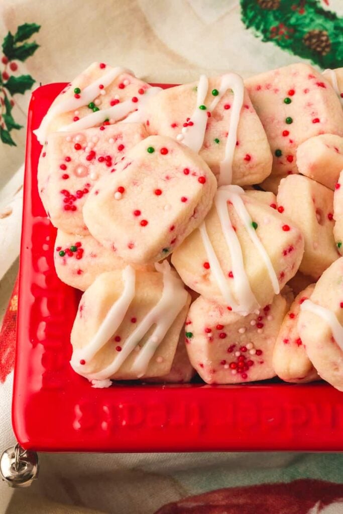 Shortbread bites in red holiday container.