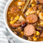 Overhead view of cowboy stew in a white bowl.