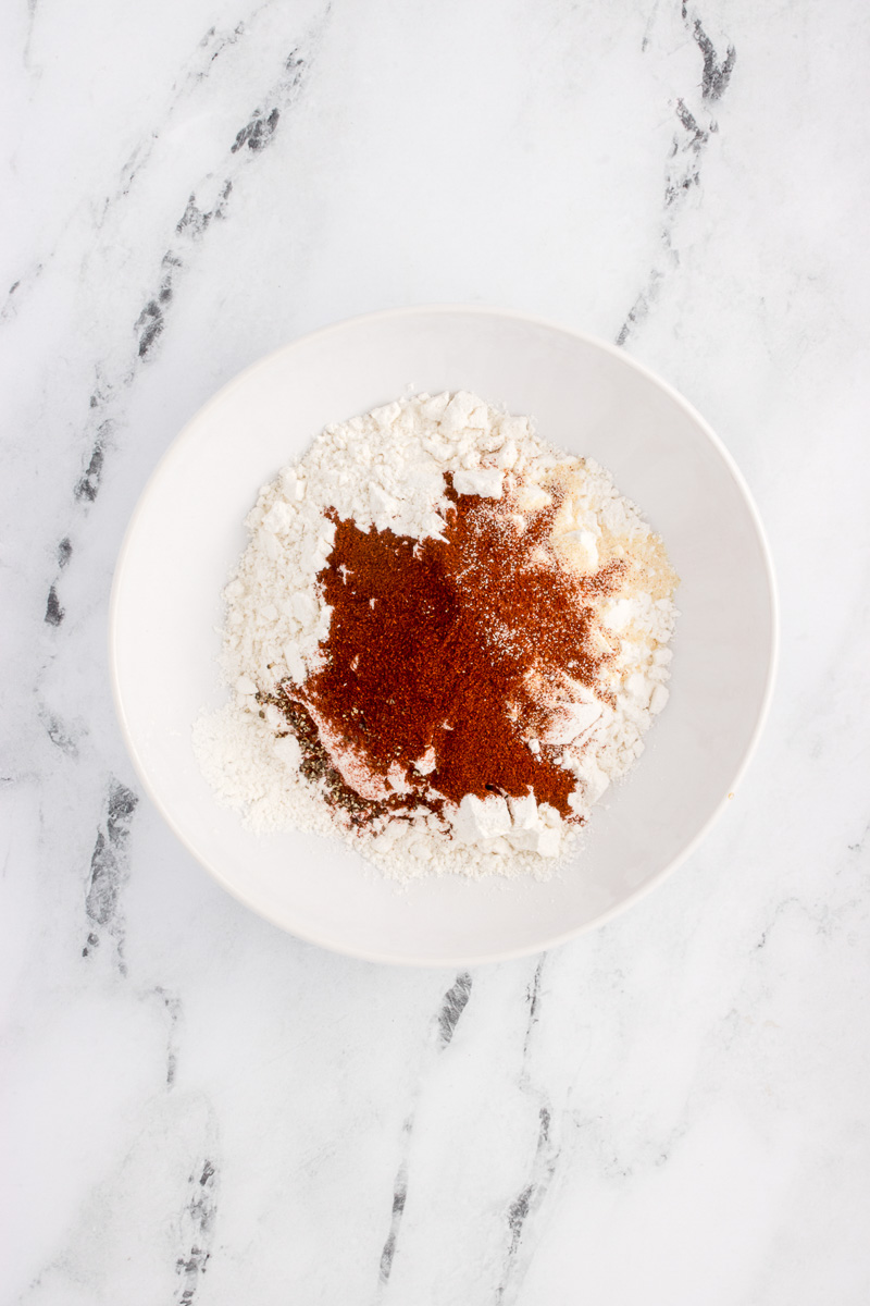 Flour and spices in white bowl.