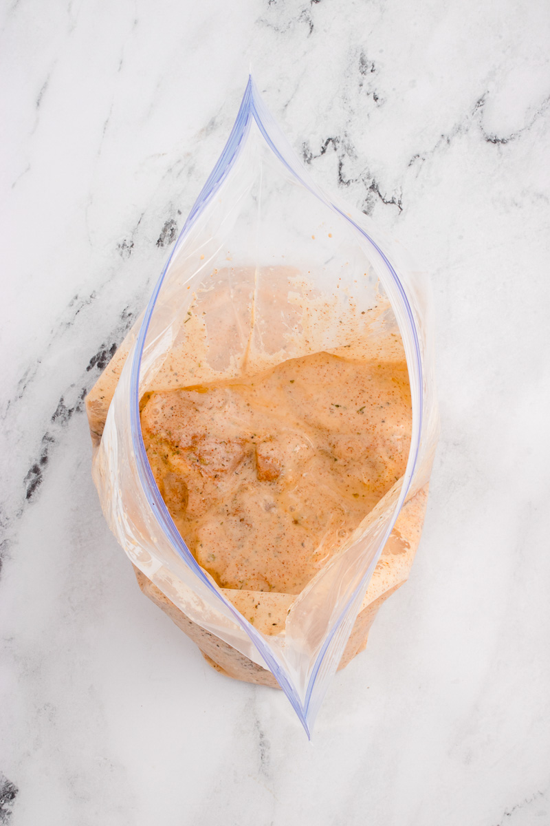Chicken pieces in Ziploc bag with spices and buttermilk.