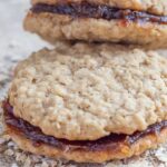 Date filled oatmeal cookies on a piece of burlap cloth.