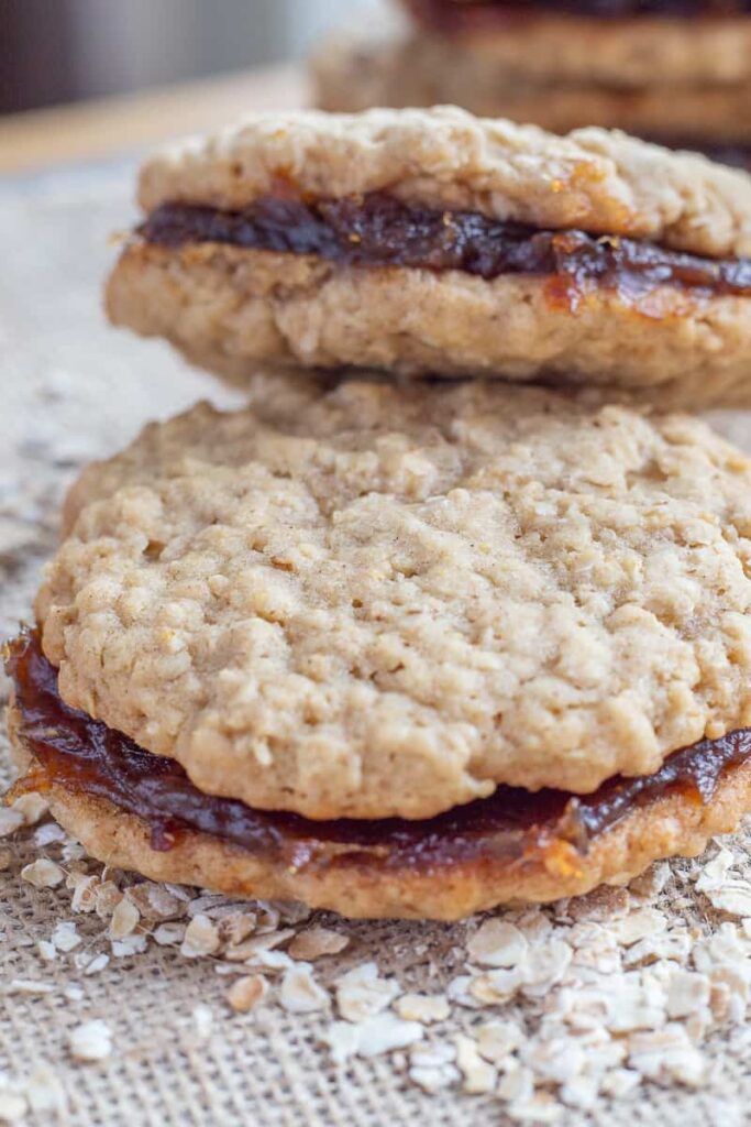 Date filled oatmeal cookies on a piece of burlap cloth.