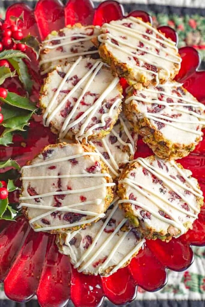Cranberry pistachio shortbread on a red plate.