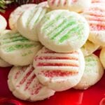 Grandma's shortbread cookies with sprinkles for Christmas on a red plate.