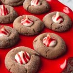 Chocolate peppermint blossom cookies on a red plate.