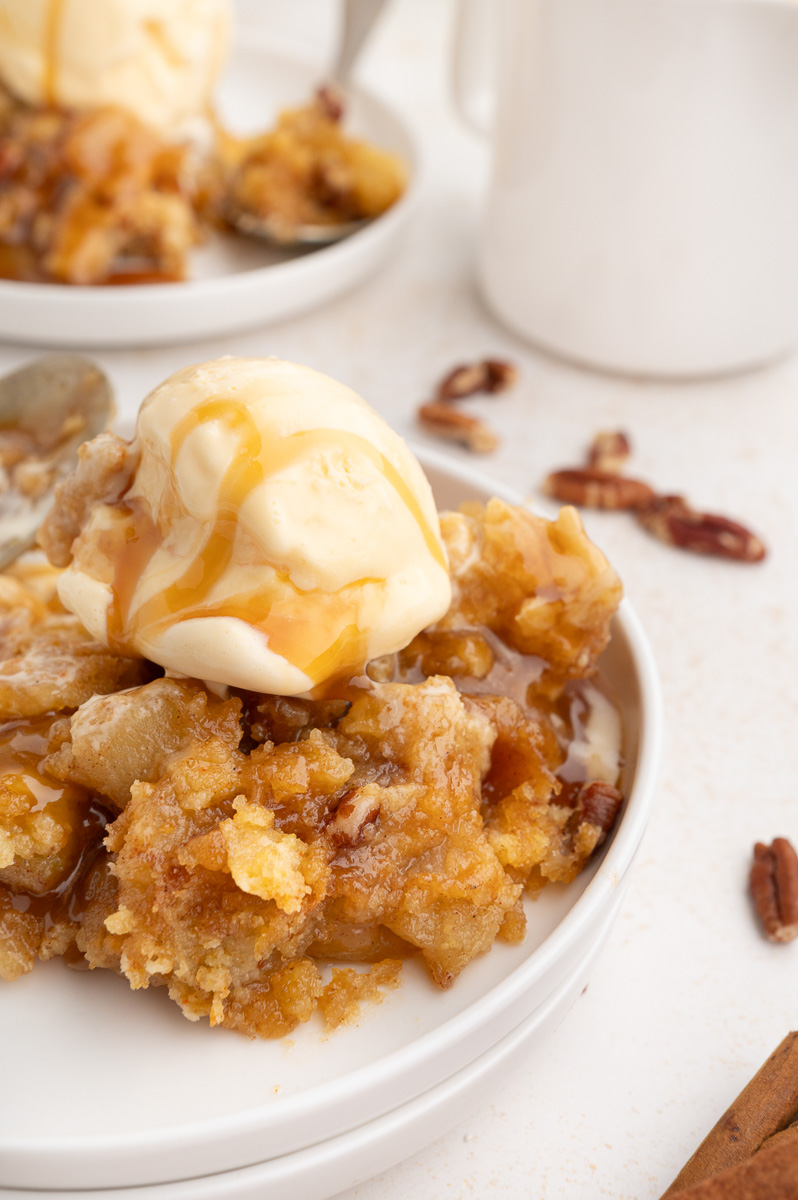 Caramel apple dump cake on a white plate.