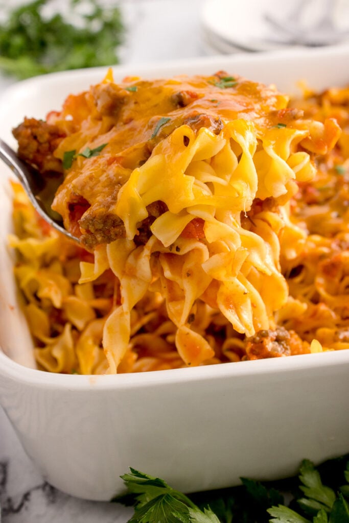 Beef noodle casserole in a white casserole dish.