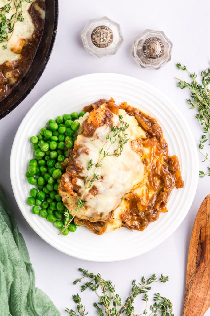 French onion chicken on a white plate.