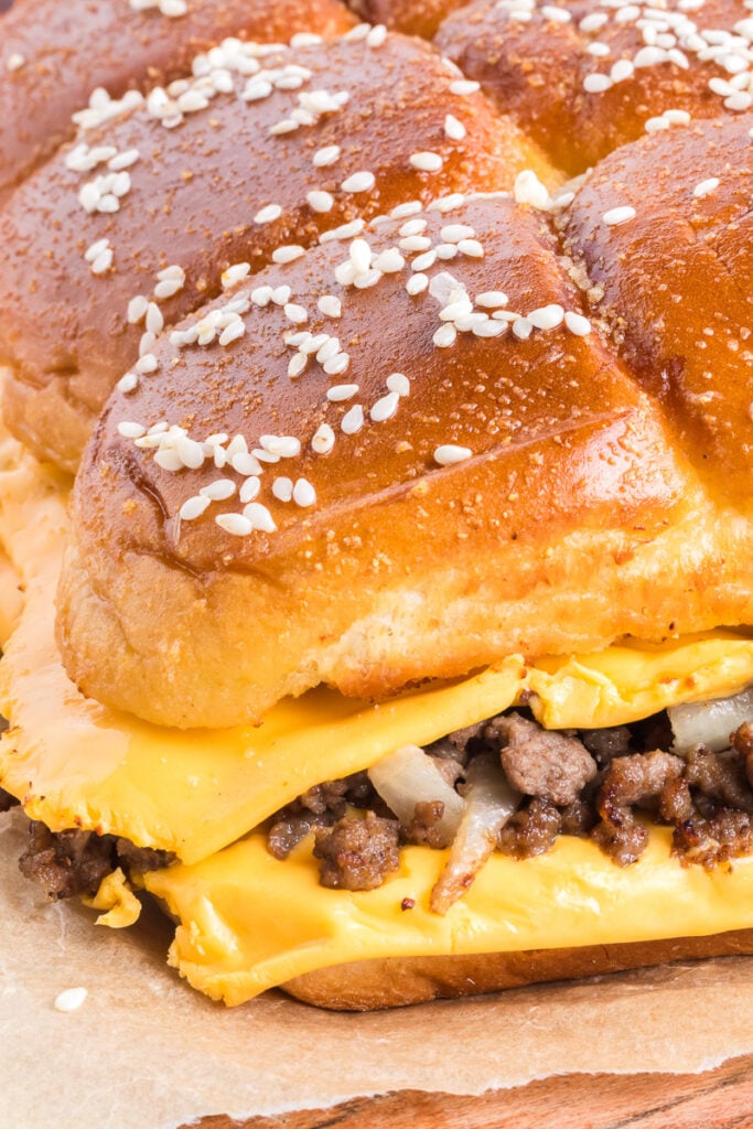 Cheeseburger sliders on parchment paper.