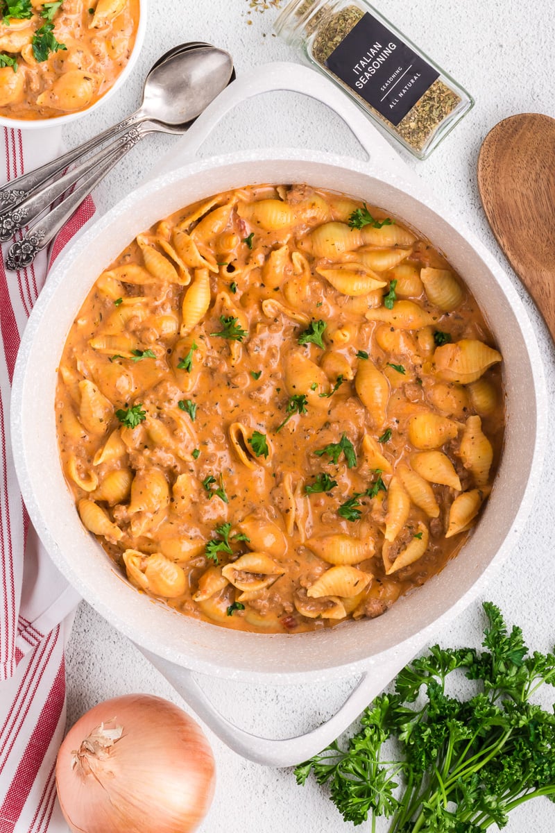 Creamy beef and shells in baking dish.