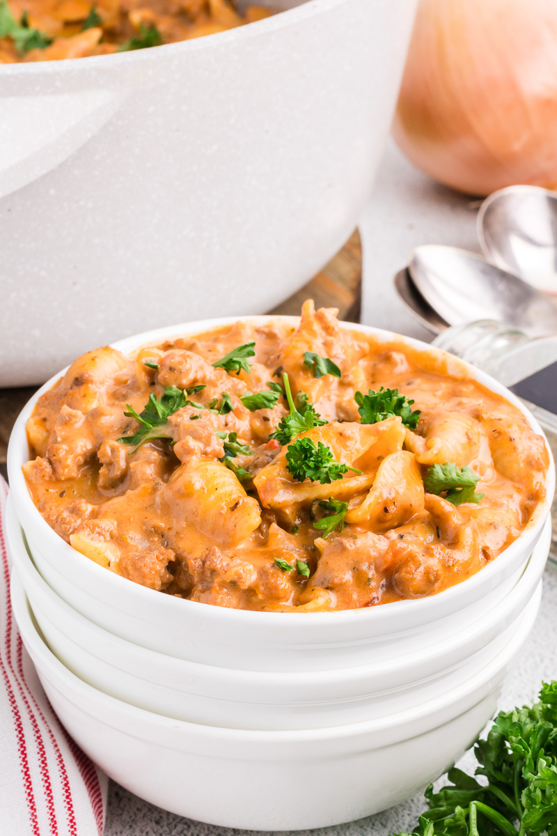 Creamy beef pasta in a white bowl.