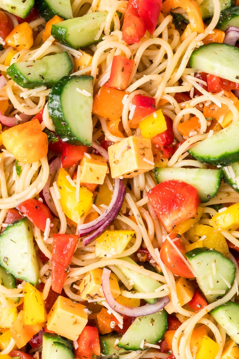 Close up image of spaghetti pasta salad with Italian dressing.