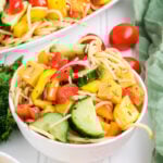 Spaghetti pasta salad in a white bowl.