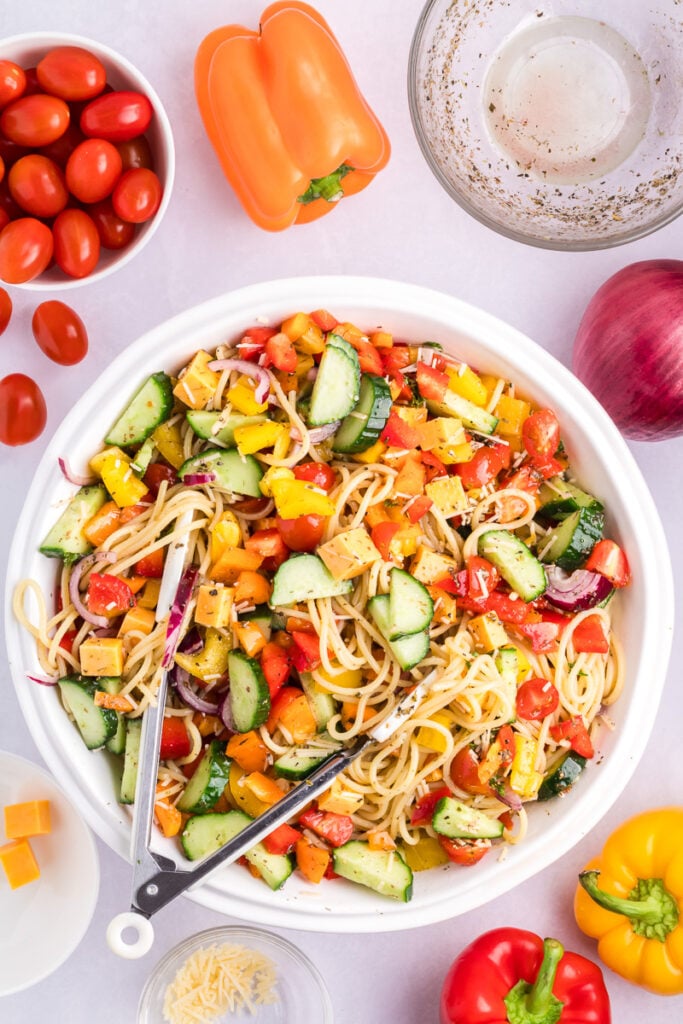 Spaghetti salad in a white bowl.