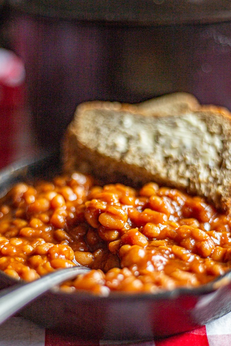 Homemade baked beans in a small cast iron skillet.