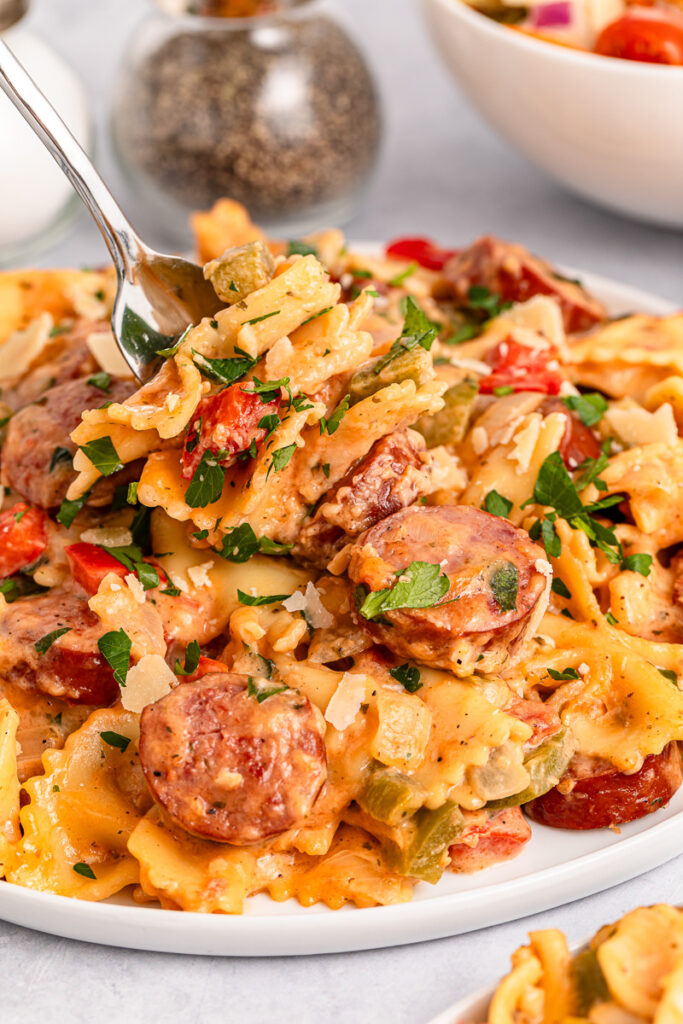 Kielbasa pasta on a white plate.