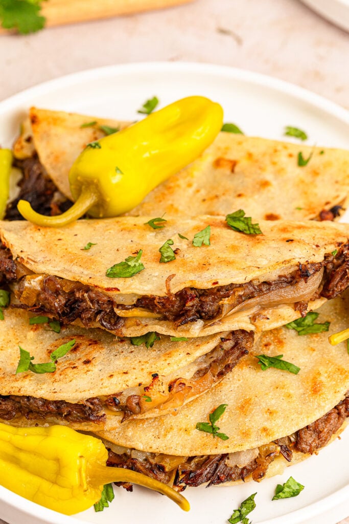 Mississippi pot roast tacos on a white plate.