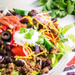 Beef taco salad on a white plate.