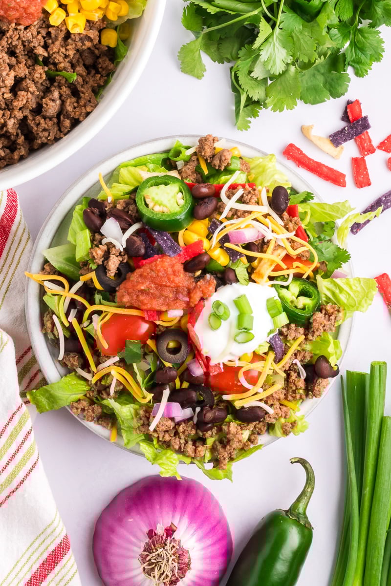 Overhead image of beef taco salad on a white plate.