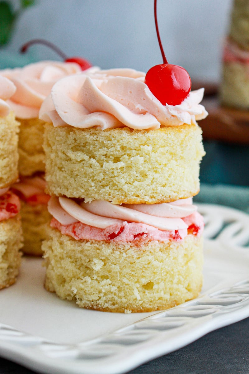 Cherry almond mini layer cakes on a white plate.