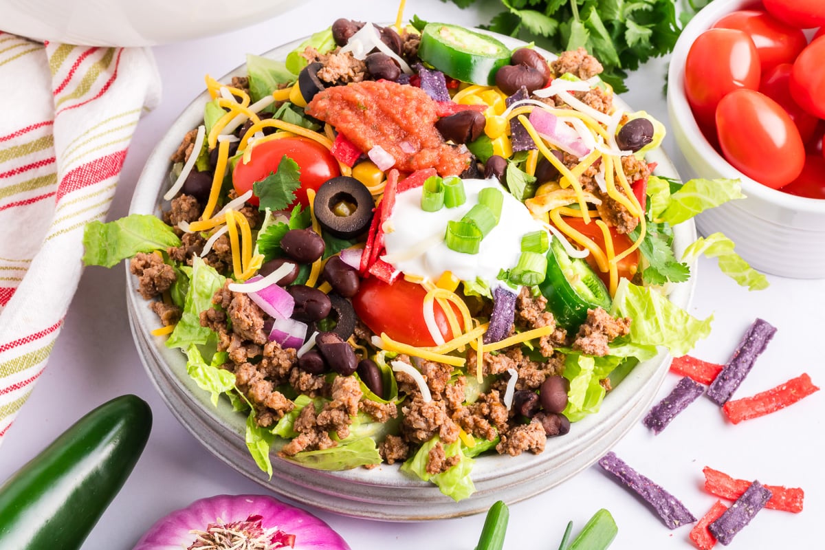 Beef taco salad in a glass bowl.