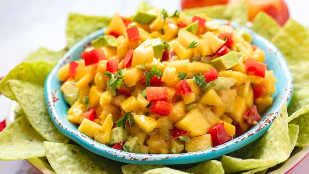 Peach mango salsa in a blue bowl.